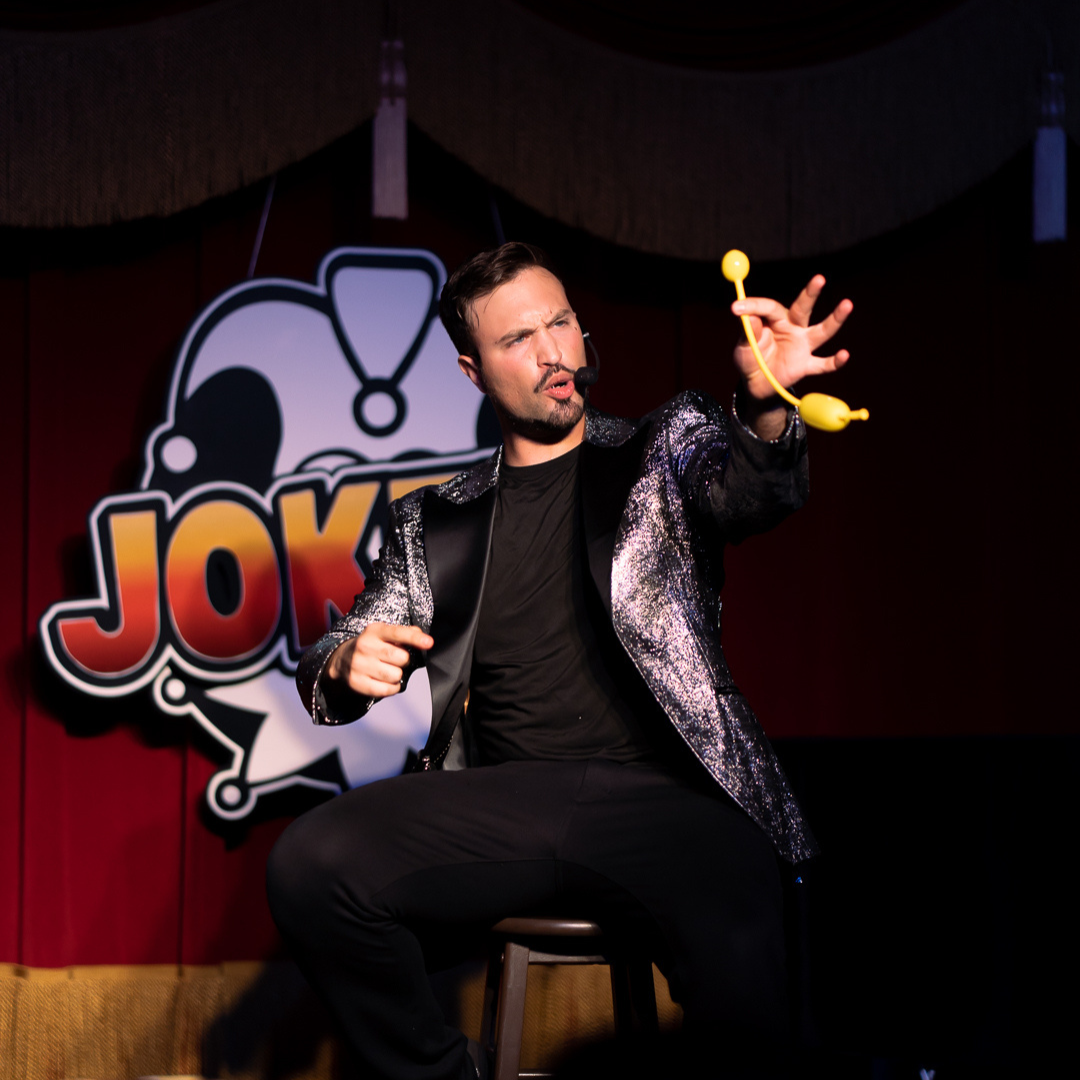 Aaron Matthews entertaining children at an outdoor theater