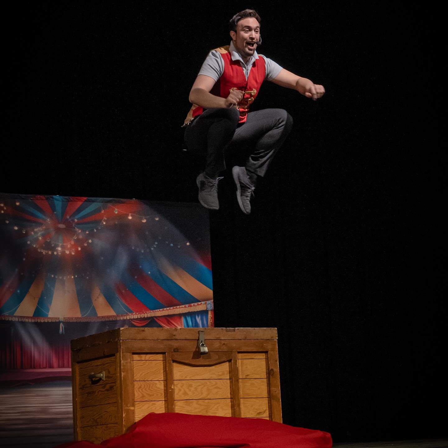 Aaron Matthews performing a magic act on stage